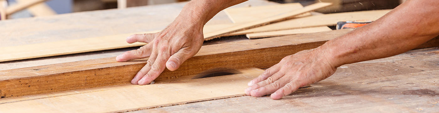 carpenter use saw cut wood for make new furniture